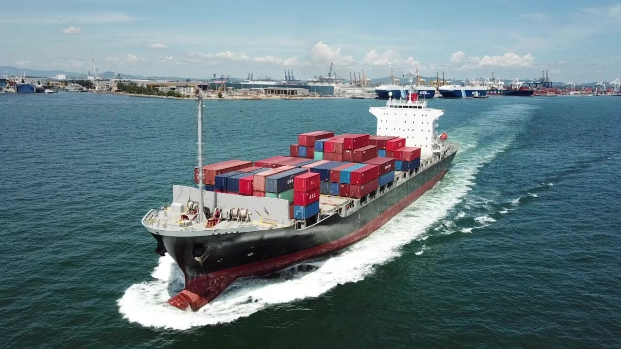 A container ship carrying export cargo out to sea