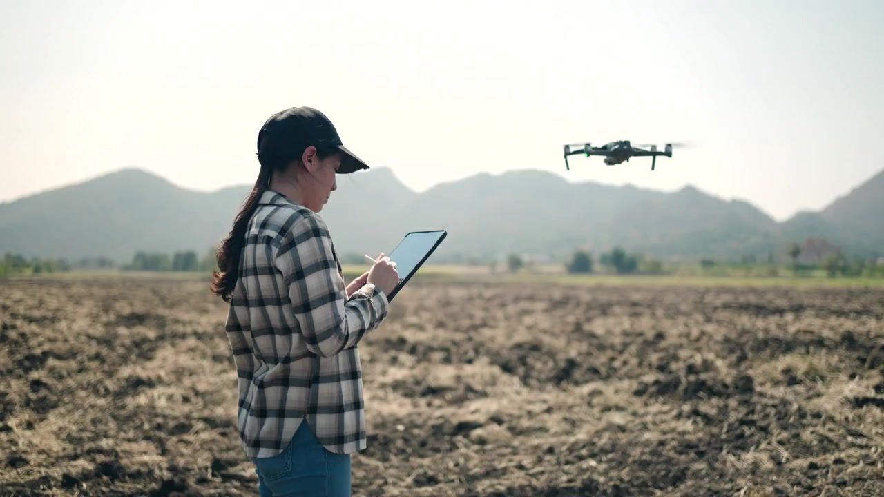 A field technician flying a survey drone over open land