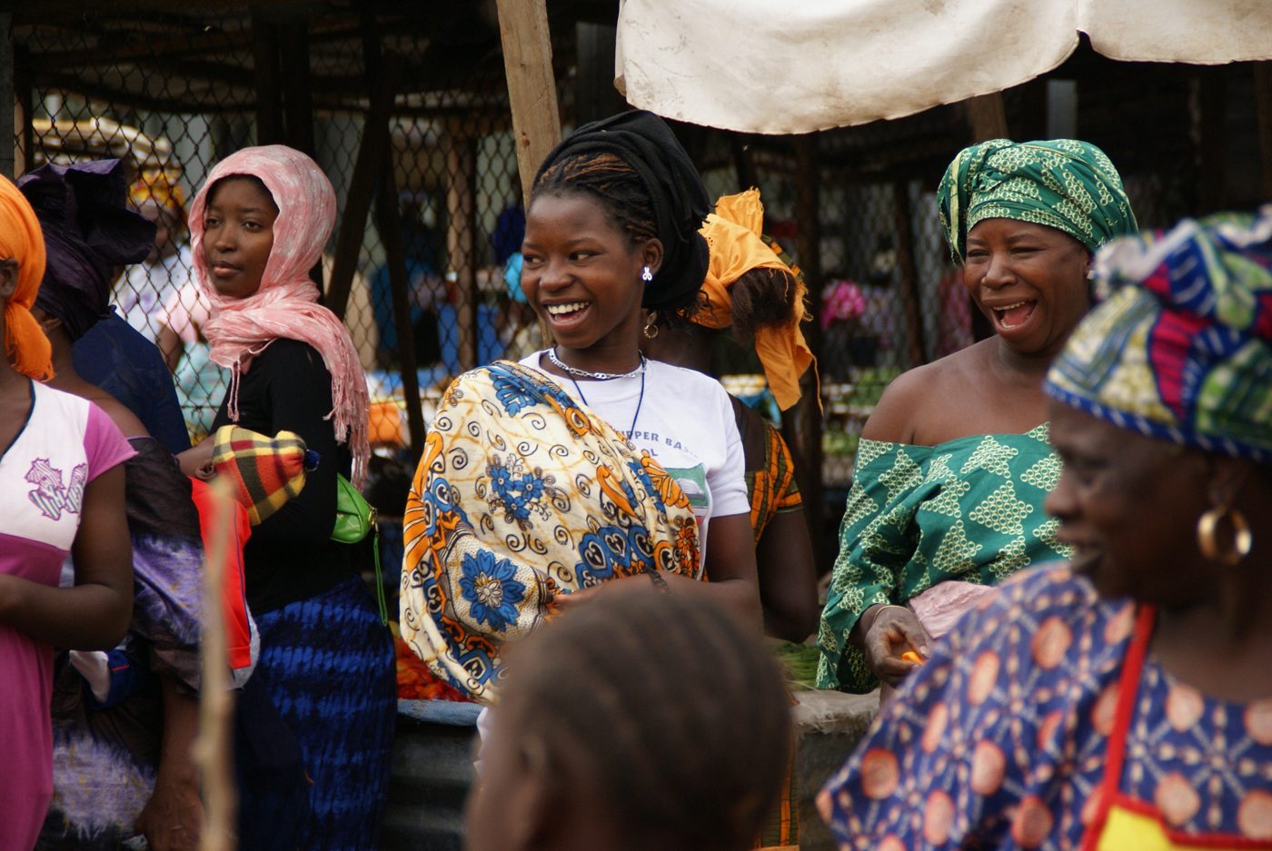 Women trading at a busy, colourful local market
