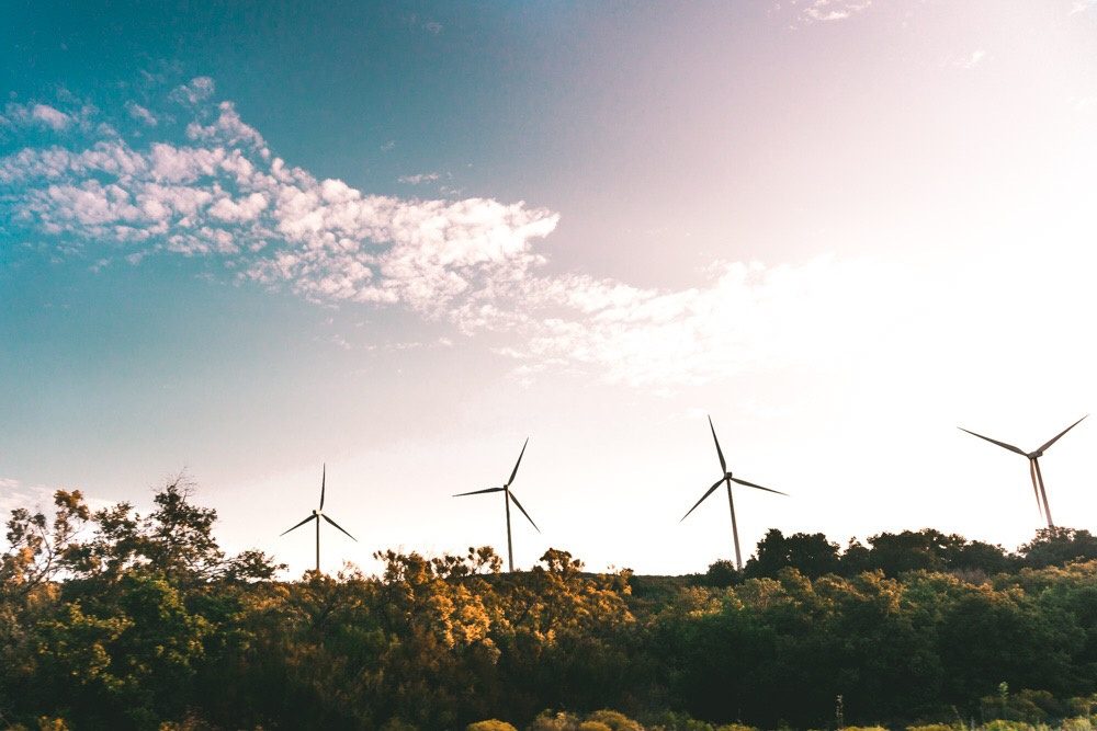 Wind turbines on a ridge against an evening sky